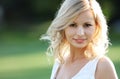 Smiling blonde girl. Portrait of happy cheerful beautiful young woman, outdoors. Royalty Free Stock Photo