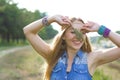 Horizontal closeup portrait of a cheerful hippie on nature background