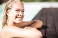 Smiling blonde leaning on pools edge Royalty Free Stock Photo