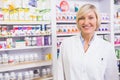 Smiling blonde pharmacist posing in lab coat Royalty Free Stock Photo