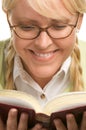 Smiling Blonde With Ponytails Reads a Book Royalty Free Stock Photo