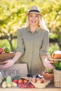 Smiling blonde presenting the table of local food Royalty Free Stock Photo