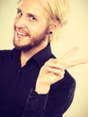 Smiling blonde showing peace gesture Royalty Free Stock Photo