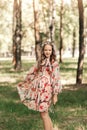 Smiling blonde teen girl posing in summer garden. Wearing flower wreath outdoors Royalty Free Stock Photo