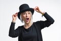 Smiling blonde woman in black hat isolated on white background. Young woman with beautiful smile happy and excited Royalty Free Stock Photo