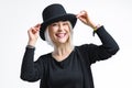 Smiling blonde woman in black hat isolated on white background. Young woman with beautiful smile happy and excited Royalty Free Stock Photo