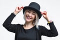 Smiling blonde woman in black hat isolated on white background. Young woman with beautiful smile happy and excited Royalty Free Stock Photo