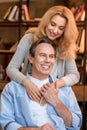 Smiling blonde woman hugging happy mature man Royalty Free Stock Photo