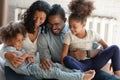 Smiling bonding mixed race family enjoying relaxed playtime.