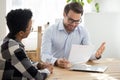 Smiling boss holding cv interviewing black woman Royalty Free Stock Photo