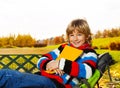 Smiling boy in autumn park Royalty Free Stock Photo