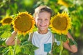 A smiling boy with a basket of sunflowers. Smiling boy with sunflower. A cute smiling boy in a field of sunflowers. Royalty Free Stock Photo