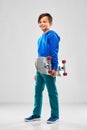 Smiling boy in blue hoodie with skateboard