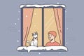 Smiling boy and cat in window during winter Royalty Free Stock Photo