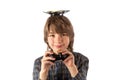 Smiling boy with a drone on top of his head and holding the quad