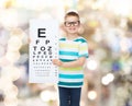 Smiling boy in eyeglasses with white blank board Royalty Free Stock Photo