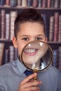 Smiling boy, first-grader with a magnifying glass Royalty Free Stock Photo