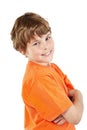 Smiling boy with folded arms stands half-turned