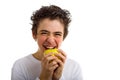 Smiling boy going to bite a yellow apple Royalty Free Stock Photo