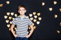 Smiling boy with golden heart wings