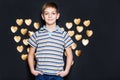 Smiling boy with golden heart wings
