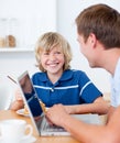 Smiling boy having breakfast with his father Royalty Free Stock Photo