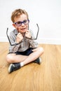 Smiling boy having dilemma, enjoying picking new eyeglasses