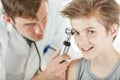 Smiling boy having his ear examination Royalty Free Stock Photo