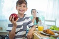 Smiling boy holding an apple Royalty Free Stock Photo