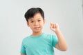 Smiling boy holding a capsule of vitamin on a white background Royalty Free Stock Photo