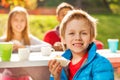 Smiling boy holding cupcake with his friends Royalty Free Stock Photo