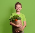 Smiling boy holding paper shopping bag full of fresh organic fru Royalty Free Stock Photo