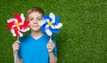 Smiling boy holding pinwheels