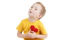 Smiling boy holding a red heart figurine. symbol of love, family, . Concept of the family and children. Royalty Free Stock Photo