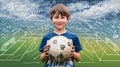 Smiling boy holding soccer ball with soccer tactic scheme on background