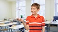 smiling boy holding toy wind turbine at school Royalty Free Stock Photo