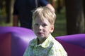 Smiling boy on inflatable trampolina outdoors