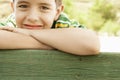 Smiling Boy Leaning On Wooden Railing Royalty Free Stock Photo