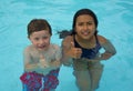 Smiling boy and little girl swimming Royalty Free Stock Photo