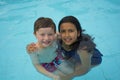 Smiling boy and little girl swimming Royalty Free Stock Photo