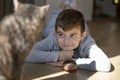 Smiling boy looking with love his pet, cat at home Royalty Free Stock Photo