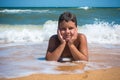 Smiling boy lying on the beach, outdoors Royalty Free Stock Photo