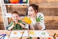 Smiling boy and mother showing hands painted in colorful paints Royalty Free Stock Photo