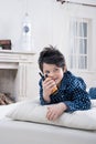 Smiling boy in pajamas using walkie-talkie on bed Royalty Free Stock Photo