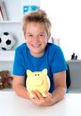 Smiling boy with piggy-bank Royalty Free Stock Photo