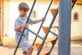 Smiling Boy On Playground Climbs Slide On Summer Day. Fun Pastime. Happy Childhood.