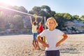 Smiling boy playing beach volleyball with friends Royalty Free Stock Photo