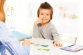 Smiling boy plays developing game with cards Royalty Free Stock Photo