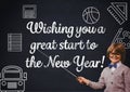 Smiling boy pointing at blackboard with new year greeting quotes Royalty Free Stock Photo