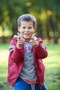 Smiling boy pointing with fingers to the camera, outdoors Royalty Free Stock Photo